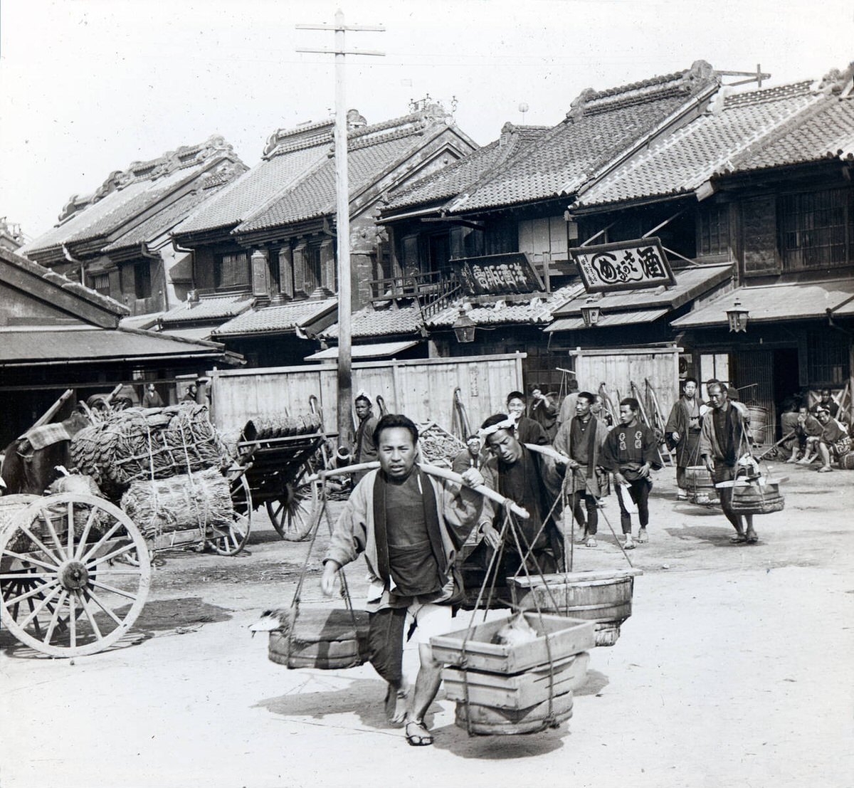Men carrying buckets at the Nihonbashi fish market in Tokyo, 1896