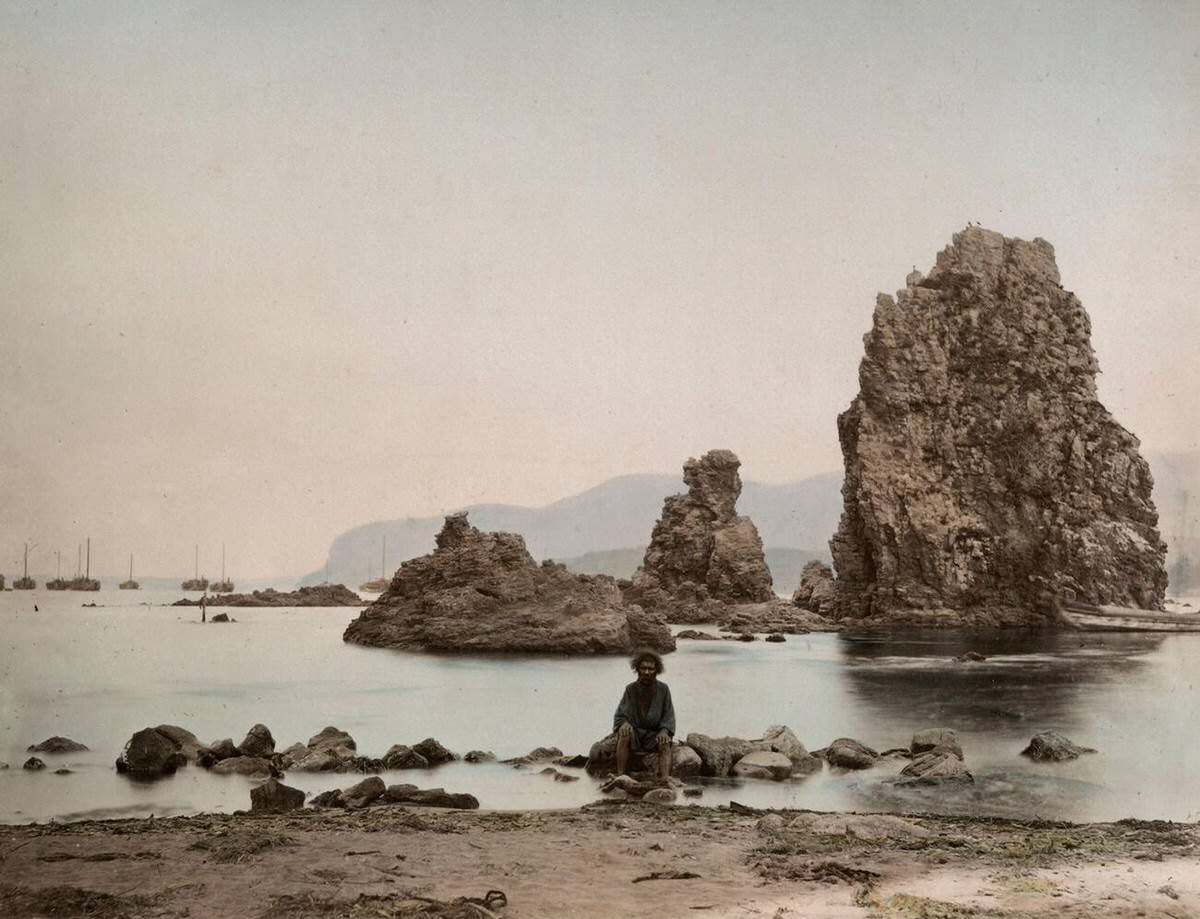 Ainu man with boats at anchor at Inos Island, 1890s