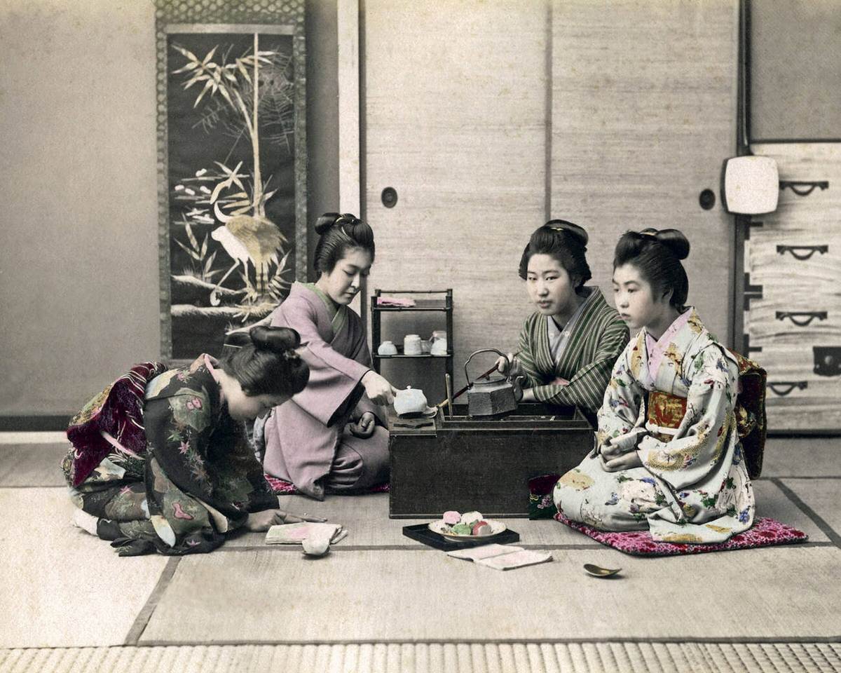 Geishas at a tea stove.