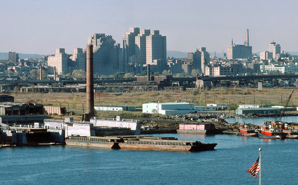 Abandoned Central Railroad of New Jersey yards and scrap barges seen from the Statue of Liberty, 1977