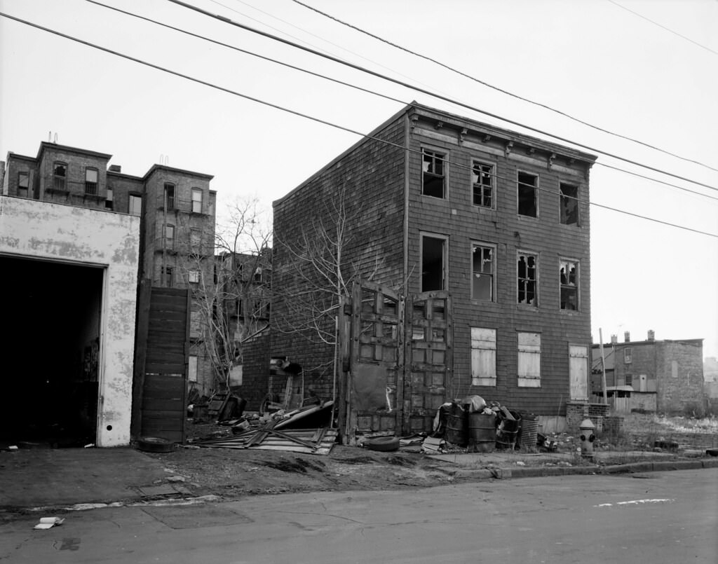 Abandoned house at 273 10th Street and surrounding littered fields in Jersey City, 1976