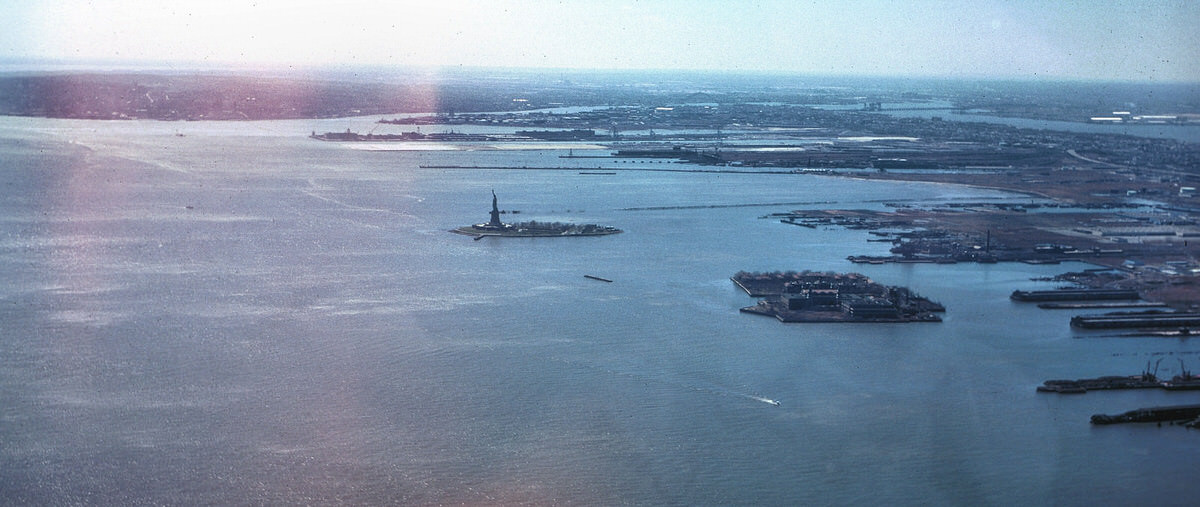 New York Harbor, the Statue of Liberty, and Ellis Island seen from the World Trade Center, 1977