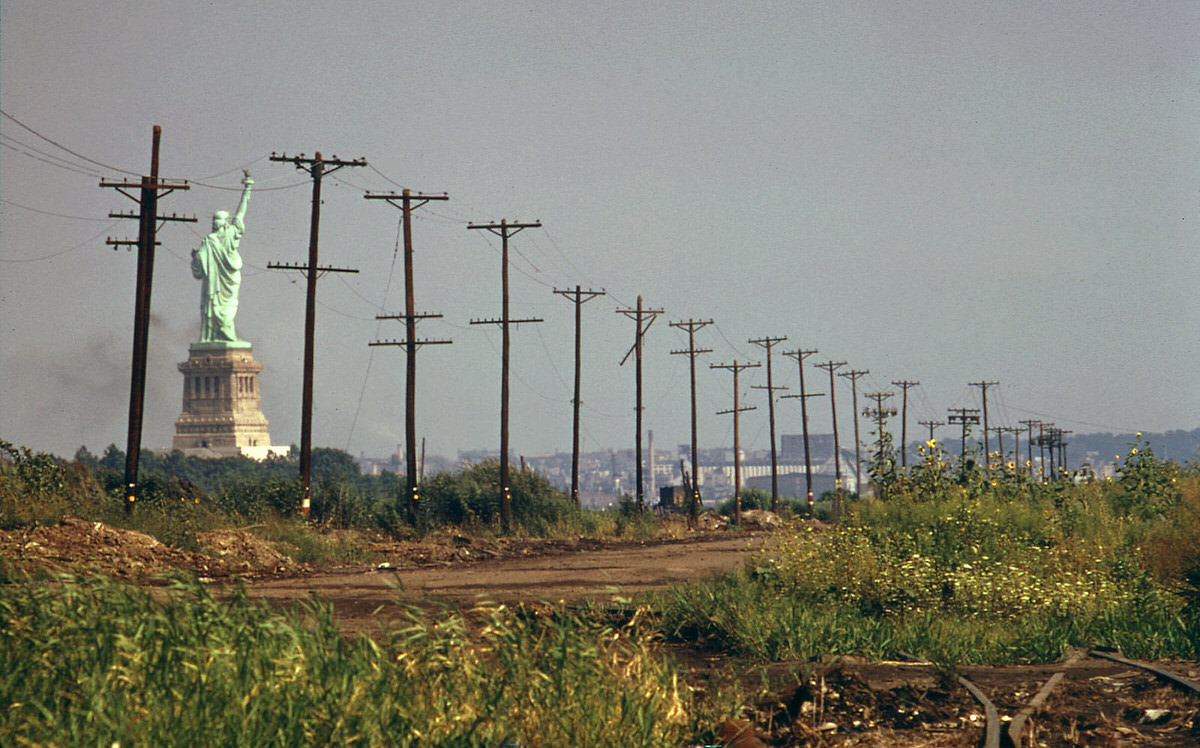 Statue of Liberty and abandoned wilderness at the future site of Liberty State Park, 1976