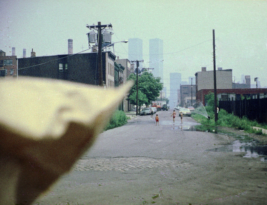 Children playing in fire hydrant spray on Dudley Street in Jersey City, 1975