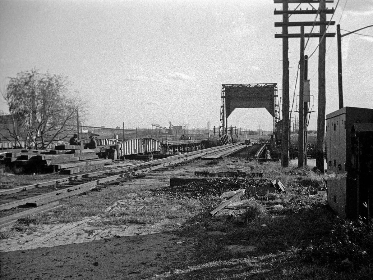 Abandoned railroad tracks over the Hackensack River with the World Trade Center in the distance, 1973