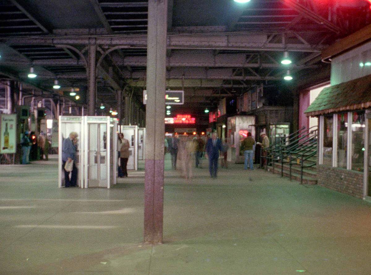 Phone booths and bus signs at the Hoboken Erie Lackawanna terminal, 1975