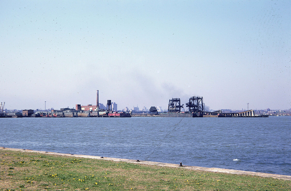 Industrial waterfront and coal unloaders in Jersey City seen from the Statue of Liberty, 1973
