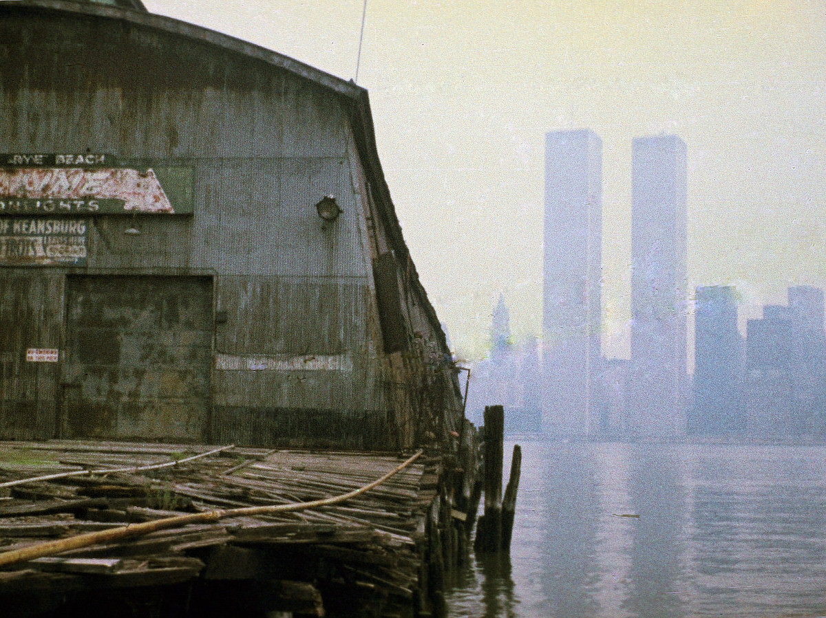 Rotting piers at Exchange Place in Jersey City with the World Trade Center in the background, 1975