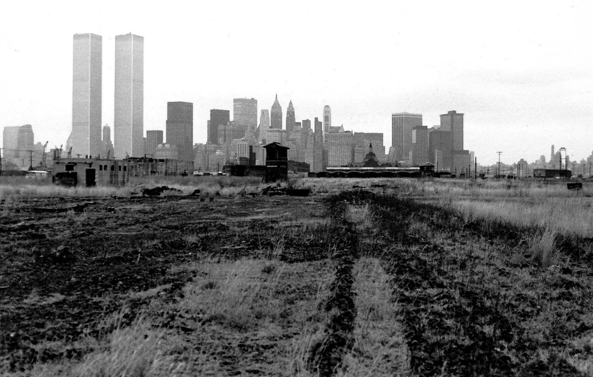 Abandoned railroad buildings and the World Trade Center in Jersey City, 1975