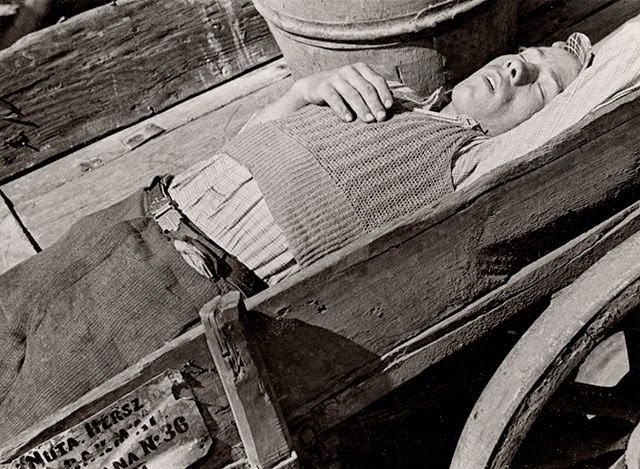 Exhausted carrier of heavy loads, Warsaw, 1930s.