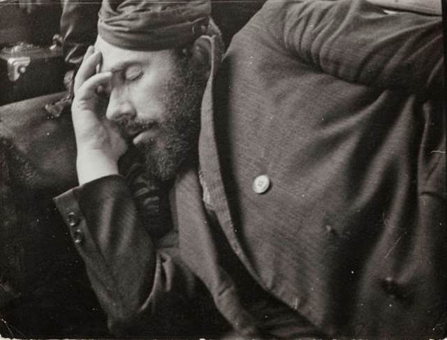 Salesman sleeping on a bench to save on lodging, Eastern Europe, 1930s.