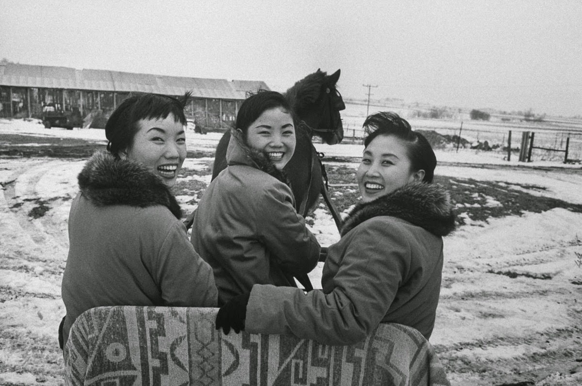 Sook Ja, Ai Ja, and Min Ja on a horse-drawn sleigh at a farm in Illinois, ,1960