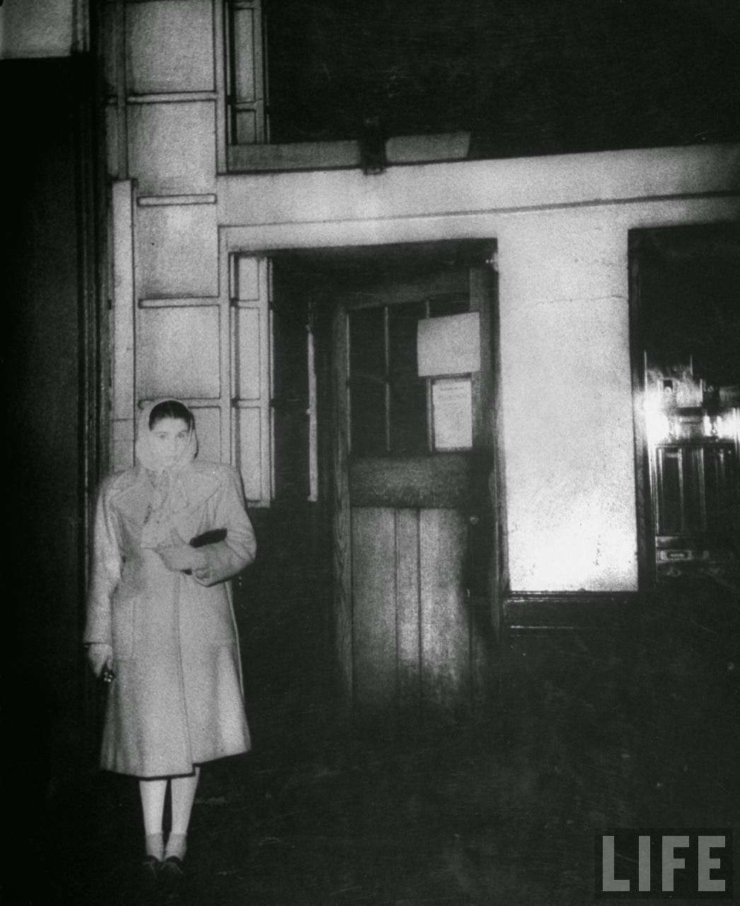 Girl waiting for a friend outside the stage door of the Windmill Theatre, 1940s