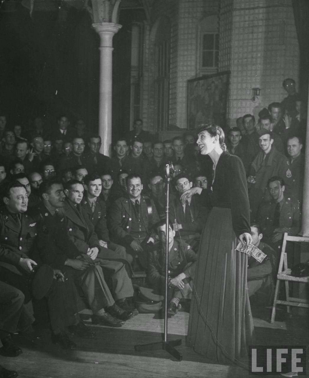 Soldiers at the Hans Crescent Club listening to singer Joyce Grenfell, 1940s