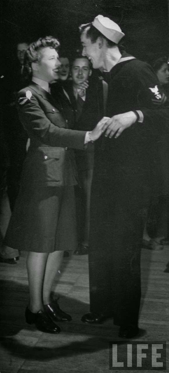 Girl talking with an American sailor, 1940s