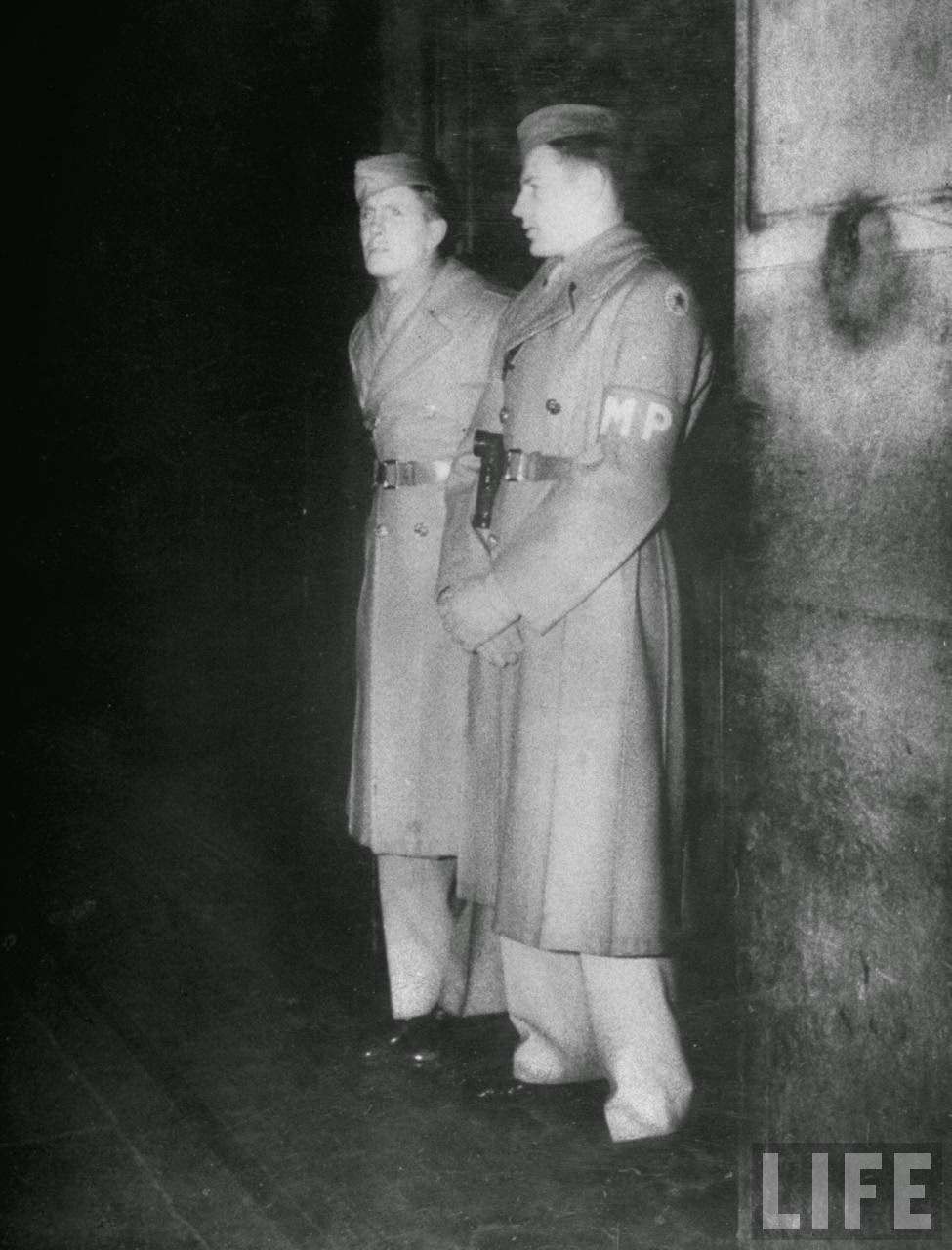 American MPs examining leave passes in Piccadilly, 1940s