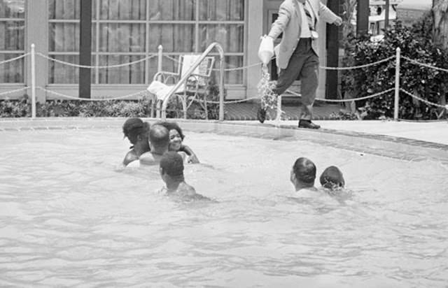 Shocking 1964 Photo Series Captured a Motel Manager Pouring “Acid” Into a Pool to Force Black People Out