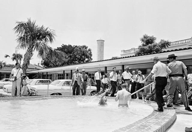 Shocking 1964 Photo Series Captured a Motel Manager Pouring “Acid” Into a Pool to Force Black People Out