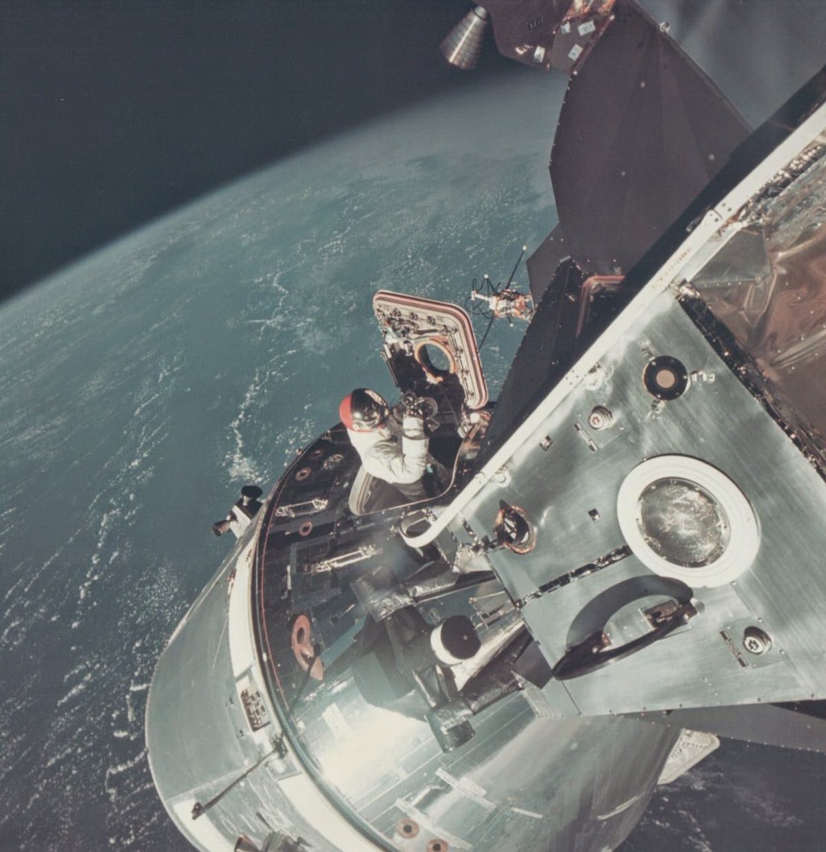 David Scott climbs out of the Command Module, Apollo 9, March 1969.