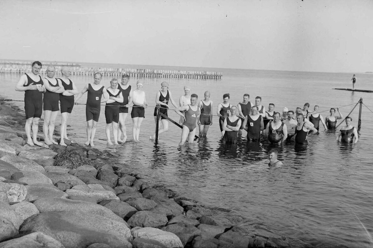 People swimming in the sea by a dike in Den Helder, 1930