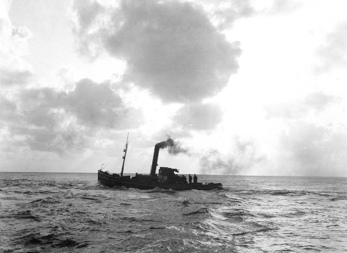 Smoking tugboat passing at sea near Den Helder, 1930