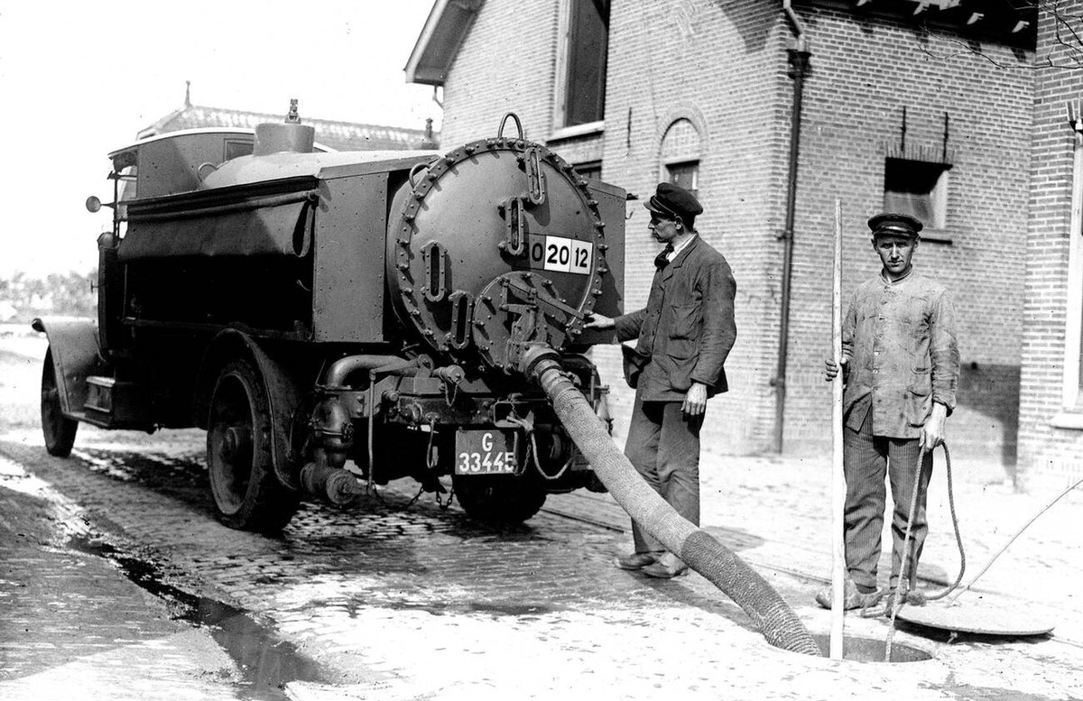 Employees with a tank truck during the draining of a sewer, 1930