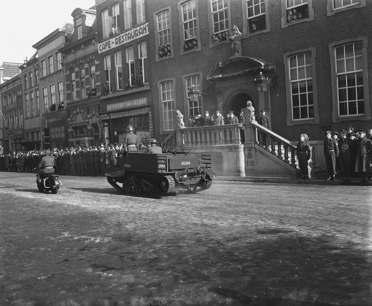 Prince Bernhard on the steps of City Hall watching a military parade in Breda, 1947