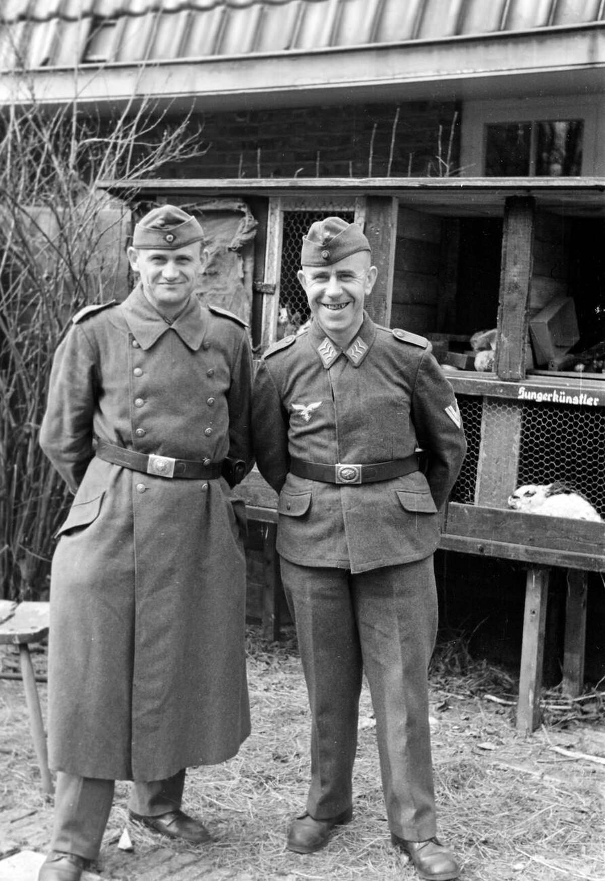 Photographer Erich Andres and a German Air Force corporal in front of rabbit cages, 1941