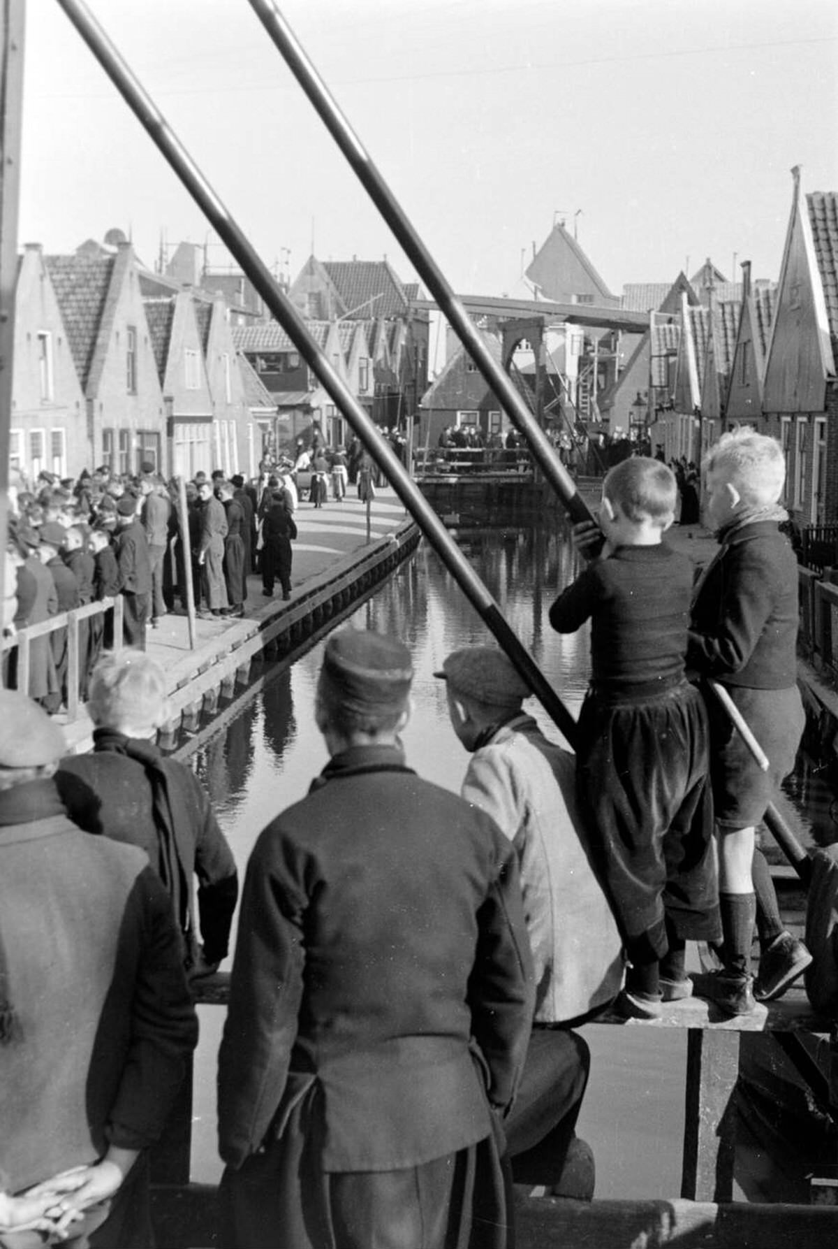 People gathering at a canal in Volendam, 1941