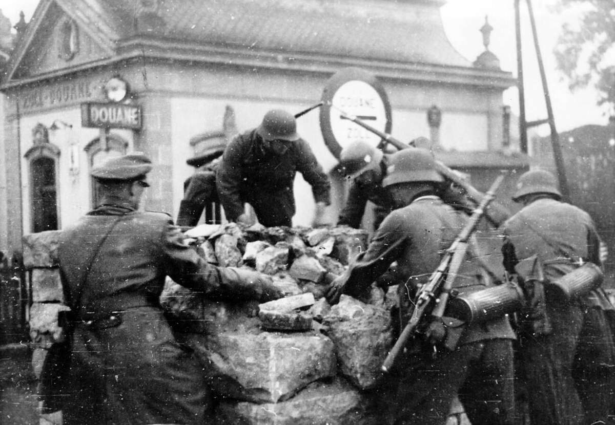 German Wehrmacht soldiers deconstructing street blocks at a border point, 1940