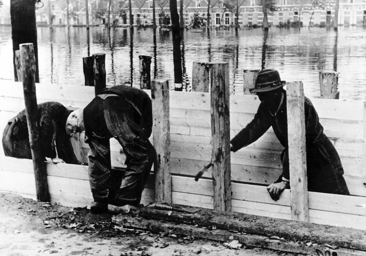 Locals building ramparts in a flooded town on the Walcheren peninsula, 1944