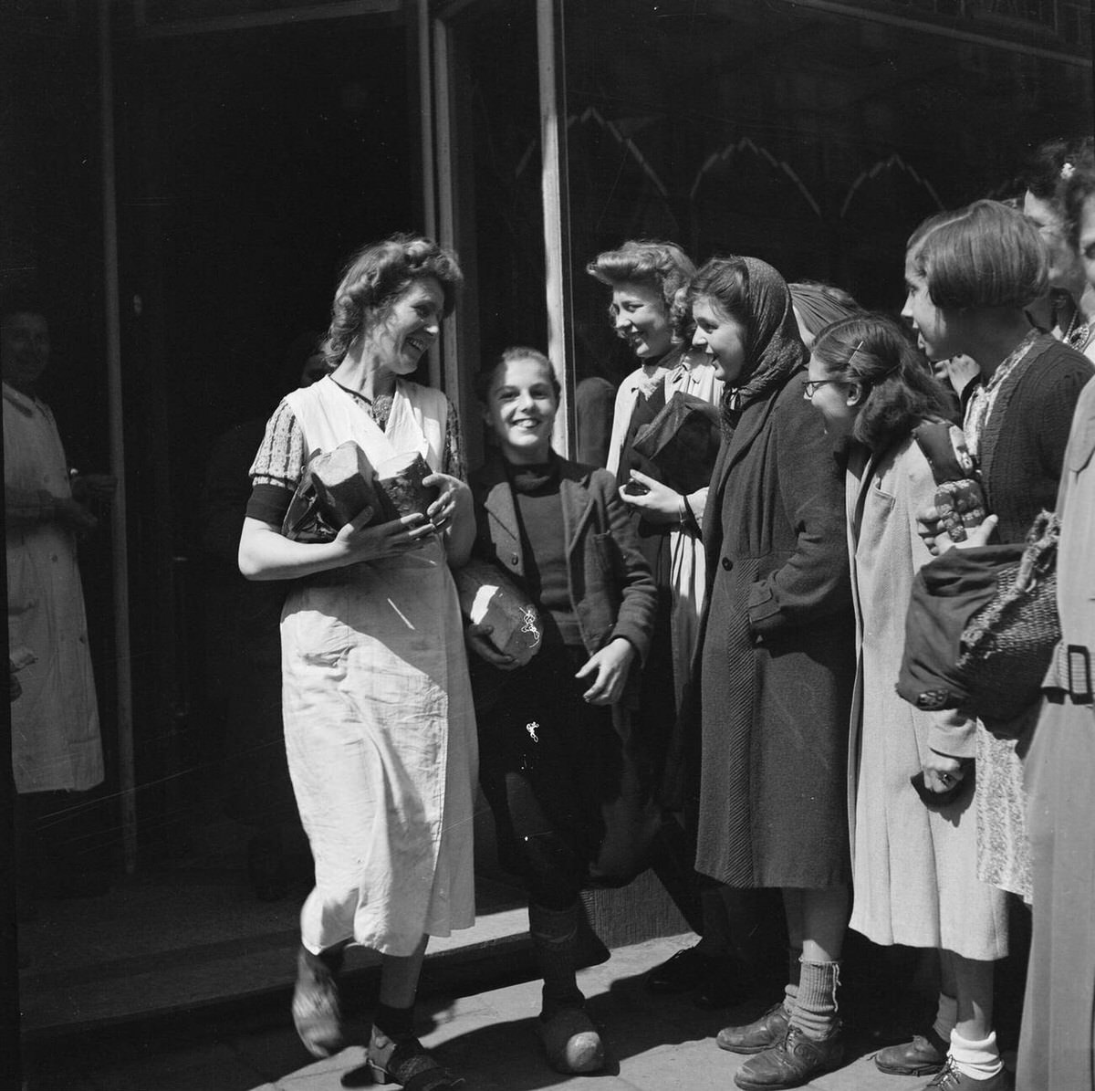 Shoppers exiting a store with food following the liberation of Amsterdam, 1945