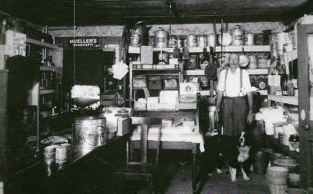 Edmund Einsiedel and his dog inside his general store in Egg Harbor City, 1930s