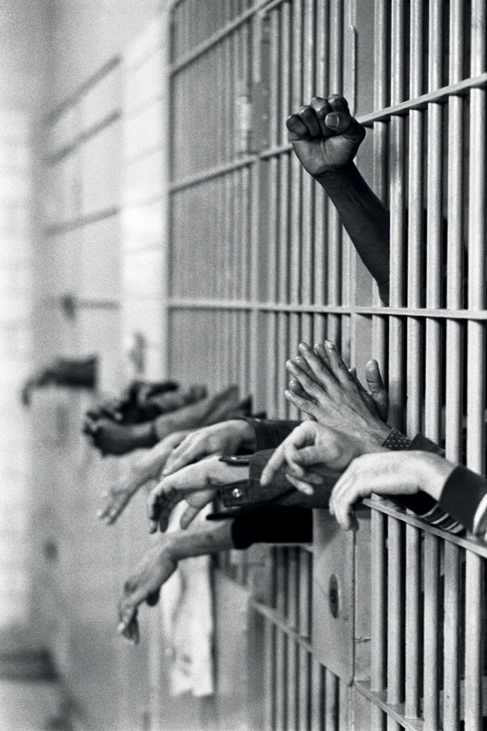 A fist raised in protest from behind the bars at Toms Prison, Manhattan, on 28 September, 1972.