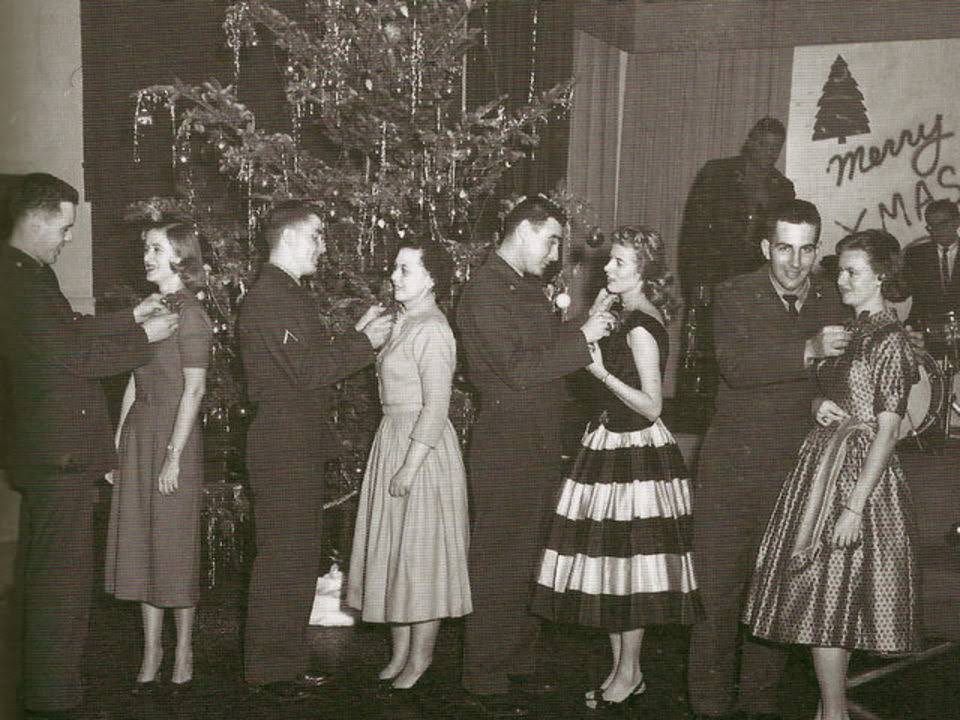 Soldiers pinning corsages on dance partners at a Christmas dance at Fort Dix, 1957