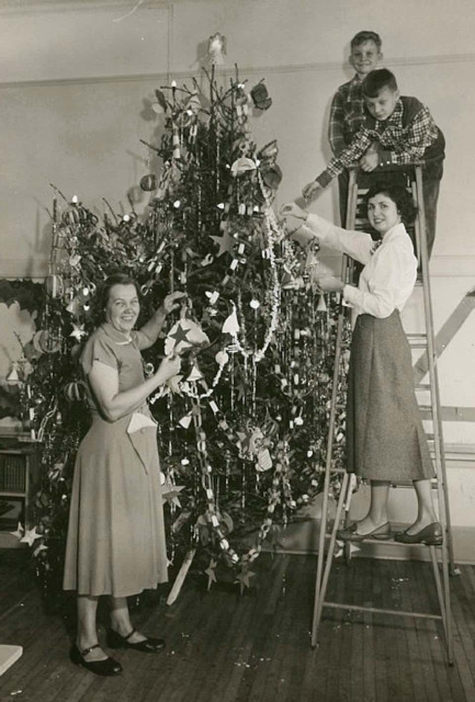 Students and staff decorating a Christmas tree at Brookdale Elementary School in Bloomfield, 1953
