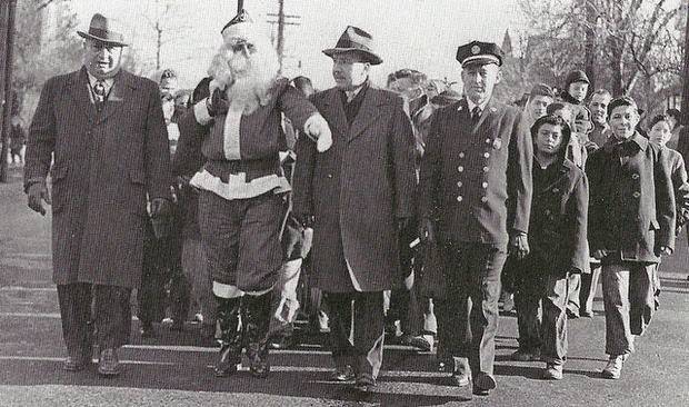 Santa Claus and city officials in a parade on Passaic Street in Garfield, 1950s