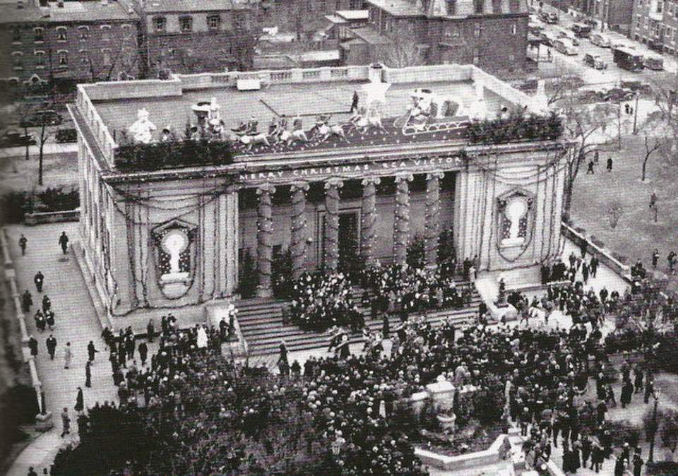 Carolers and a marching band performing at the decorated Cooper Branch Public Library in Camden, 1939
