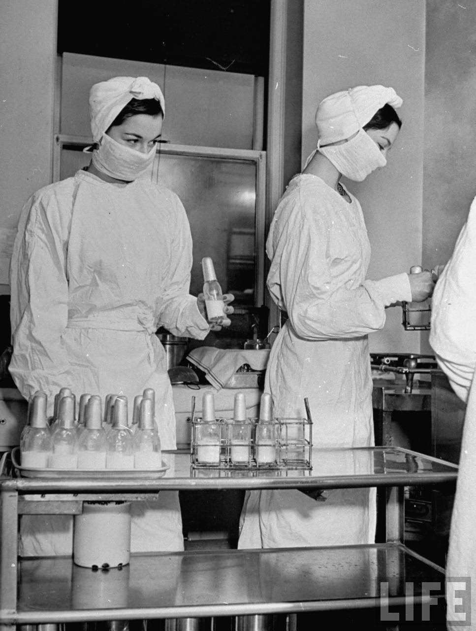 The O'Connor twins Gloria and Consuelo, helping out at hospital, almost exacat look-alikes.