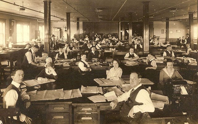 Office with sixty-four clerical workers and an adding listing machine.