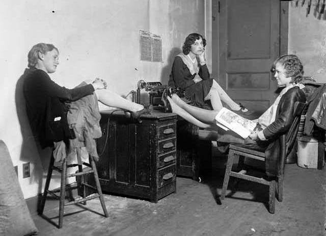 Three women at a desk with a typewriter and candlestick phone in Colorado, 1920