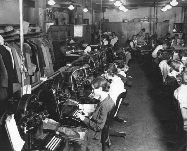 Office with thirteen Graphotype machines for embossing metal address plates.