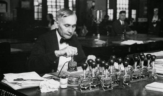 Man with eighteen Bates numbering machines.