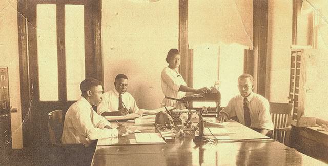 African Americans working in an office with a Burroughs Class 3 adding machine and candlestick telephone in Hempstead, Texas.
