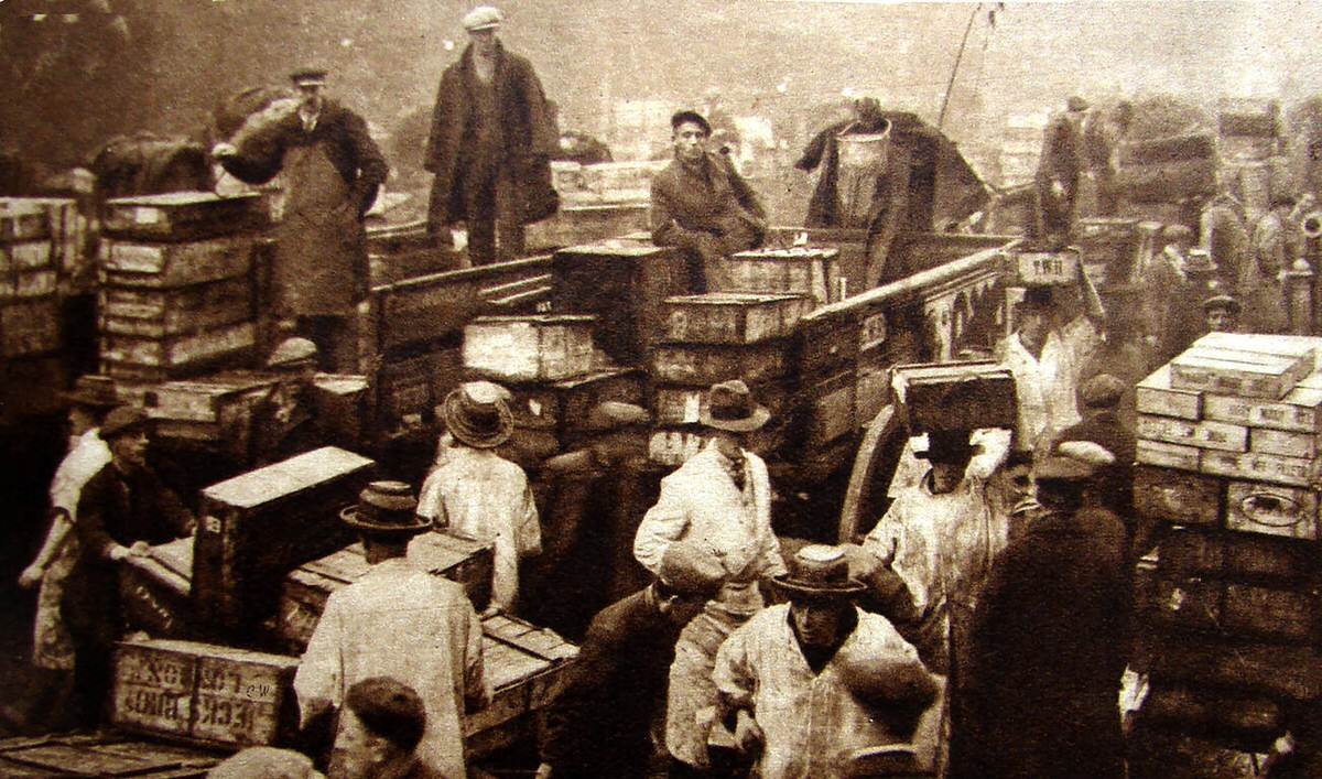 Porters loading and unloading fish at the original Billingsgate Fish Market, 1930