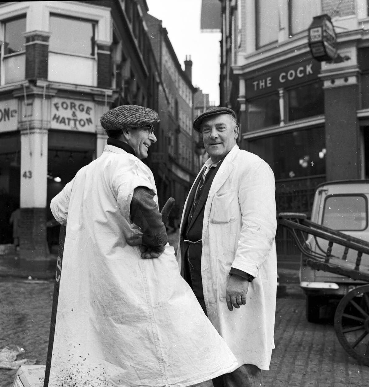 Two porters taking a break from loading crates at Billingsgate Market, 1950s