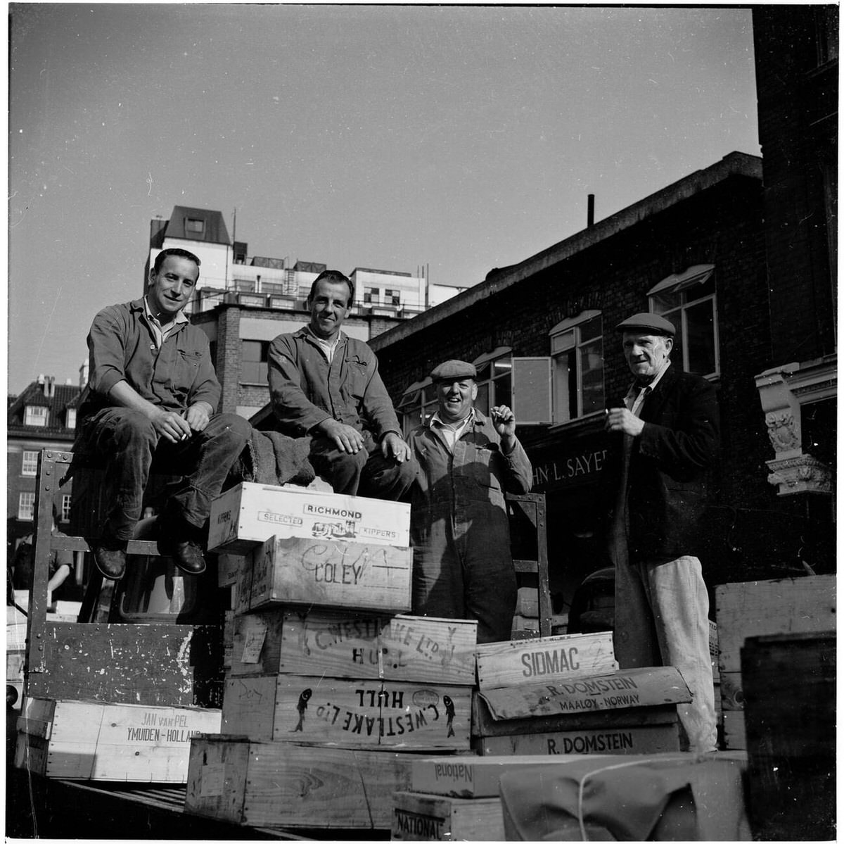 Billingsgate Fish Market workers taking a break on a truck, 1950s