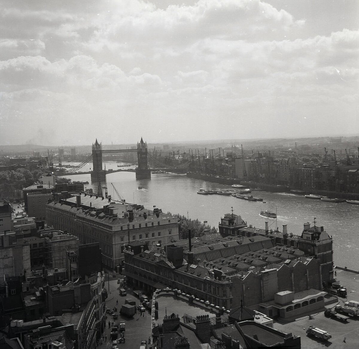 View across the River Thames to Tower Bridge with Billingsgate Fish Market at the bottom, 1950s