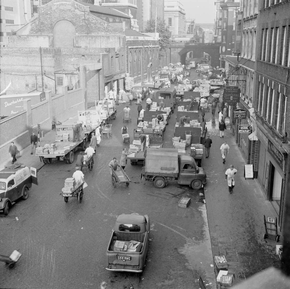 Workers, porters, and trucks filling Lower Thames Street at Billingsgate Fish Market, 1950s