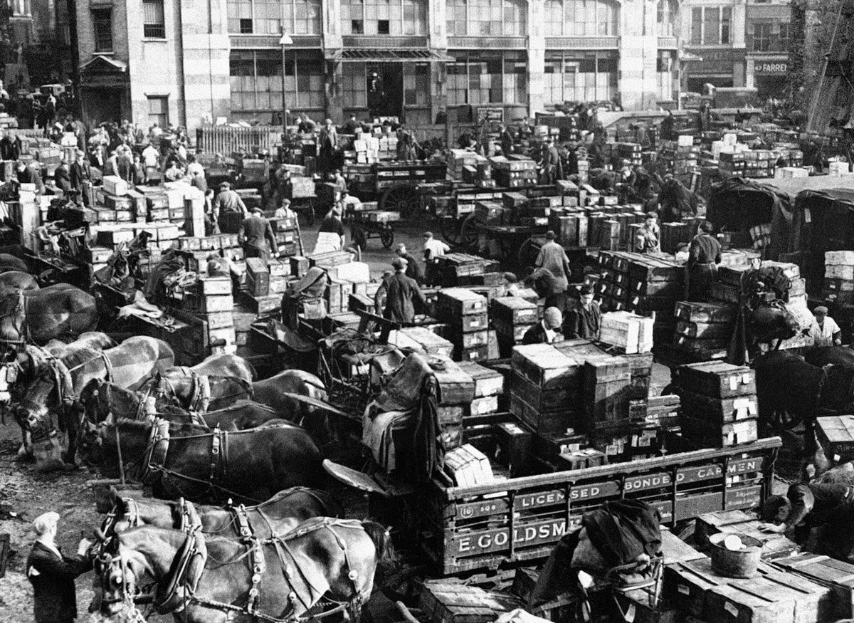 Boxes of fish being loaded onto horse-drawn carts at Billingsgate Fish Market, 1945